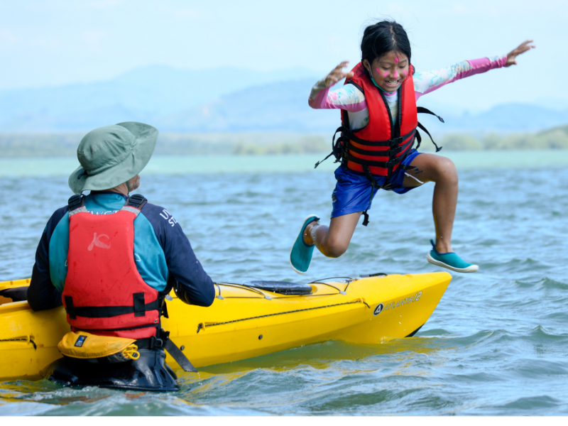 UWC Thailand student jumping into water